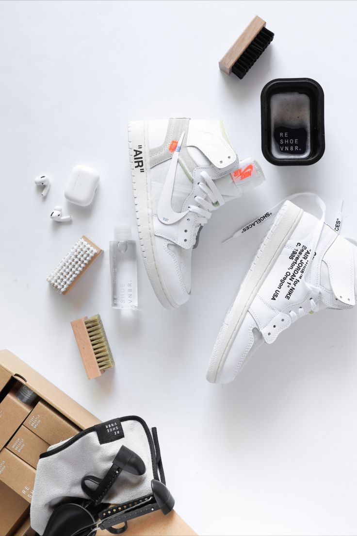 A man using a cloth on a sneaker for sneaker maintenance 